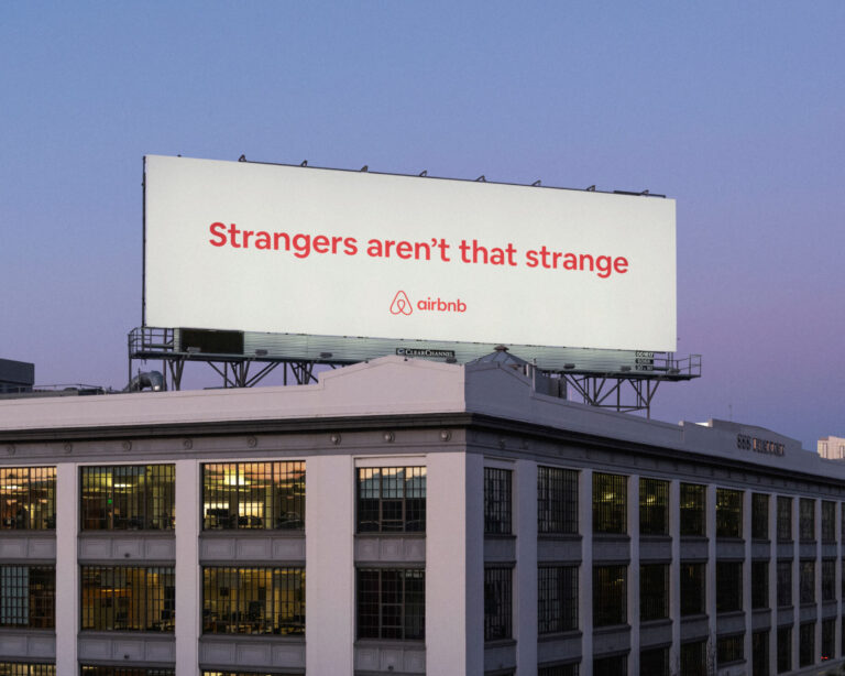 AirBnB advertising on a billboard with the words "Strangers aren't that strange"